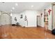 Spacious living room with hardwood floors, a double door entrance, and an open layout at 6130 Japonica Ct, New Port Richey, FL 34655