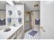Cozy bathroom featuring a swan etched shower door, patterned wallpaper, and black and white checkered tile flooring at 6428 Remus Dr, New Port Richey, FL 34653
