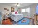 Bright bedroom with hardwood floors, decorative rug, and a large window at 6428 Remus Dr, New Port Richey, FL 34653