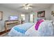 Bright bedroom with the bed, and a glimpse into the ensuite bathroom and living area at 6428 Remus Dr, New Port Richey, FL 34653