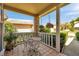 Charming front porch featuring outdoor seating, hanging floral arrangements, and tiled flooring at 6428 Remus Dr, New Port Richey, FL 34653