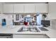 The kitchen features tile countertops and a stainless steel sink at 6428 Remus Dr, New Port Richey, FL 34653
