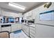 Functional kitchen featuring white appliances, ample cabinet space and tile countertops at 6428 Remus Dr, New Port Richey, FL 34653