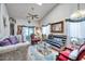 Bright and ornate living room featuring a vaulted ceiling and ceiling fan at 6428 Remus Dr, New Port Richey, FL 34653