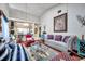 Bright living area with high ceilings, hardwood floors, and an open concept to kitchen bar at 6428 Remus Dr, New Port Richey, FL 34653