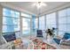 Sunroom with white wicker furniture, large windows and tile flooring offers a relaxing space at 6428 Remus Dr, New Port Richey, FL 34653