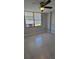 Bedroom featuring a ceiling fan, tile flooring, natural light, and air conditioner at 701 S Madison Ave # 316, Clearwater, FL 33756