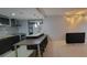 A modern kitchen with granite countertops, stainless steel appliances, and a breakfast bar at 701 S Madison Ave # 316, Clearwater, FL 33756