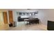 A kitchen with brown cabinets, granite countertops, stainless steel appliances, and a breakfast bar at 701 S Madison Ave # 316, Clearwater, FL 33756