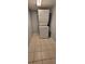 Laundry area with tile flooring and a stacked washer and dryer unit at 701 S Madison Ave # 316, Clearwater, FL 33756