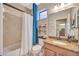 Bright bathroom with tile surround, granite counter, and white shower curtain at 7339 Skybird Rd # 7339, Bradenton, FL 34209
