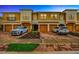 Townhome exterior featuring a two-car garage, manicured landscaping and paver driveway and sidewalk at 7339 Skybird Rd # 7339, Bradenton, FL 34209