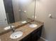 Bathroom featuring double sinks with granite countertop and dark cabinets at 778 Spring Flowers Trl, Brandon, FL 33511