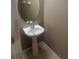 Bathroom featuring a pedestal sink and decorative mirror in a neutral color palette at 778 Spring Flowers Trl, Brandon, FL 33511