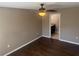 Bedroom with hardwood floors, ceiling fan, and bathroom entrance at 778 Spring Flowers Trl, Brandon, FL 33511