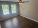 Bedroom with hardwood floors, two windows, and a ceiling fan at 778 Spring Flowers Trl, Brandon, FL 33511