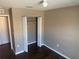Neutral bedroom featuring hardwood flooring and a closet with sliding doors at 778 Spring Flowers Trl, Brandon, FL 33511
