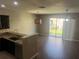 Bright dining area featuring hardwood floors, pendant light, and sliding glass door leading to the backyard at 778 Spring Flowers Trl, Brandon, FL 33511