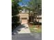 Two-story townhouse with a well-manicured lawn and a light brown colored facade at 778 Spring Flowers Trl, Brandon, FL 33511