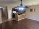 Open-concept living room with hardwood floors, fan, and pendant lights at 778 Spring Flowers Trl, Brandon, FL 33511