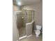 Bathroom featuring a glass-enclosed shower with tile surround and toilet at 778 Spring Flowers Trl, Brandon, FL 33511