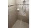 Close up of a tiled shower with a shower head and a soap dish at 778 Spring Flowers Trl, Brandon, FL 33511