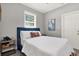 Comfortable bedroom with a blue headboard and bright window at 7800 Causeway N Blvd, St Petersburg, FL 33707
