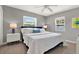 Bright bedroom with two windows, two side tables and white bedding at 7800 Causeway N Blvd, St Petersburg, FL 33707