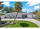 Charming single-story home with a well-manicured front yard and a large palm tree at 7800 Causeway N Blvd, St Petersburg, FL 33707
