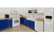 The gorgeous kitchen features custom blue cabinets, butcher block countertops, and stainless steel appliances at 7800 Causeway N Blvd, St Petersburg, FL 33707