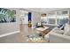 Inviting living room with seamless access to the modern kitchen and outdoor entertaining area at 7800 Causeway N Blvd, St Petersburg, FL 33707