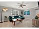Cozy living room with a large window, comfortable seating, and decorative plants at 7800 Causeway N Blvd, St Petersburg, FL 33707