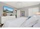 Relaxing bedroom with large TV, dresser, and slider closet doors at 7800 Causeway N Blvd, St Petersburg, FL 33707