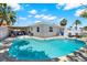 Stunning backyard featuring a kidney-shaped pool with clear water and ample seating for relaxation and entertainment at 7800 Causeway N Blvd, St Petersburg, FL 33707