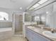 Bright bathroom featuring a soaking tub, separate shower, and double sinks at 7933 Floradora Dr, New Port Richey, FL 34654