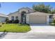 Well-maintained one story home with a two-car garage, manicured lawn and landscaping, and inviting front entrance at 7933 Floradora Dr, New Port Richey, FL 34654