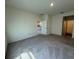 Large carpeted bedroom with neutral walls and easy access to other rooms at 7937 Wheat Stone Dr, Zephyrhills, FL 33540