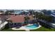 Aerial view showcasing pool, outdoor patio, and red tile roof at 8053 13Th S Ave, St Petersburg, FL 33707