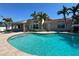 Inviting backyard featuring a sparkling pool, patio area, and lush green landscaping at 8053 13Th S Ave, St Petersburg, FL 33707