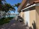 Side exterior view showing stucco, brick walkway, plam trees, and waterfront at 8053 13Th S Ave, St Petersburg, FL 33707