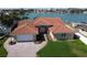 Beautiful home with a well-manicured lawn, a brick driveway and a two-car garage at 8053 13Th S Ave, St Petersburg, FL 33707