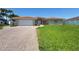 Attractive one-story home with a well-manicured lawn, arched entry, and a two-car garage at 8053 13Th S Ave, St Petersburg, FL 33707