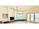 Spacious living room with fireplace, large windows, and water views at 8053 13Th S Ave, St Petersburg, FL 33707