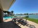 Outdoor patio with table and chairs overlooking the pool and waterfront views at 8053 13Th S Ave, St Petersburg, FL 33707