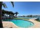 Beautiful view of the pool surrounded by palm trees with water views at 8053 13Th S Ave, St Petersburg, FL 33707