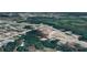Aerial shot featuring a property marked in red, surrounded by lush greenery and a mix of residential homes in a neighborhood at 9161 Codel Loop, New Port Richey, FL 34654