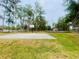 Basketball court in Moon Lake Park with tall pines, adjacent to a playground and picnic areas at 9161 Codel Loop, New Port Richey, FL 34654