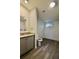 Bathroom with grey vanity, granite counters, and grey wood-look floors at 9161 Codel Loop, New Port Richey, FL 34654