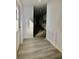 Inviting entryway features modern grey wood-look floors and freshly painted white walls at 9161 Codel Loop, New Port Richey, FL 34654