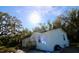 A quaint, one-story home is surrounded by lush greenery and natural light at 9161 Codel Loop, New Port Richey, FL 34654